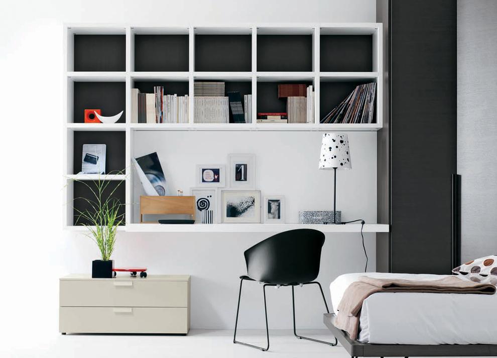 Clean contemporary office space with wall shelving units around and above the desk..